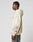 Someone in profile stands against a light background wearing the LIVE FAST DIE YOUNG LFDY Window Hooded, an oversize light beige hoodie with reflektierender Druck, a graphic print on the left sleeve, front pocket, and paired with gray jeans.