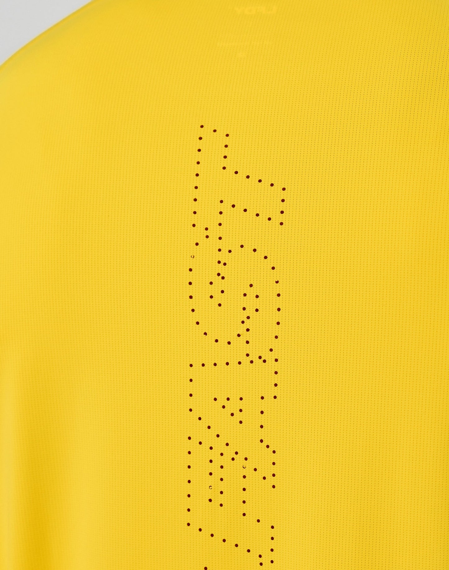 Close-up of the yellow Live Fast Performance Longsleeve by LIVE FAST DIE YOUNG, featuring a reflective front print with FAST vertically spelled out in small black dots.