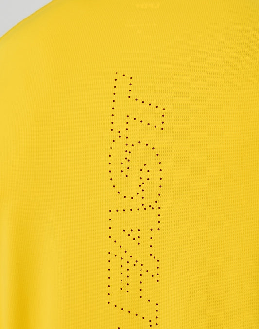 Close-up of the yellow Live Fast Performance Longsleeve by LIVE FAST DIE YOUNG, featuring a reflective front print with FAST vertically spelled out in small black dots.