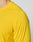Close-up of a person wearing the LIVE FAST DIE YOUNG Live Fast Performance Longsleeve in bright yellow. Only the shoulder, upper arm, and part of the neck are shown against a plain light background.