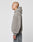 A person with a shaved head stands in profile against a white background, wearing a gray, textured, oversize fit LIVE FAST DIE YOUNG LFDY Teddy Hooded jacket with Eingrifftaschen and faded gray jeans.
