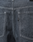 Close-up of the back of the LFDY Baggy Denim jeans by LIVE FAST DIE YOUNG, featuring dark gray 100% cotton fabric, two back pockets with white stitching, and a small black tag on the right pocket.