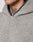 Close-up of a person in the LFDY Teddy Hooded by LIVE FAST DIE YOUNG, a light grey textured fleece hoodie with an oversize fit. Only the lower face and neck with a black and grey floral tattoo are partially visible.