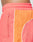 Close-up of a person wearing LIVE FAST DIE YOUNG Beach Shorts in coral pink and orange with zip pockets, a wide elastic waistband, white piping, and a comfortable Regular Fit.