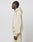 A person in profile stands against a white background, wearing the LIVE FAST DIE YOUNG Basic 360 Hooded—an oversize beige hoodie and matching sweatpants crafted from soft Baumwolle and durable polyester, with hands relaxed by their sides.
