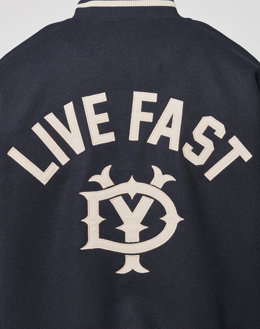 The Live Fast College Jacket by LIVE FAST DIE YOUNG is a navy blue Regular Fit jacket with LIVE FAST boldly in white on the back, above a stylish Y and D emblem, and features Rückenstick Gefüttert for extra comfort and style.