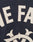 Close-up of cream-colored stitched E and F letters with Rückenstick detail and ornate design on dark fabric, likely from the Live Fast College Jacket by LIVE FAST DIE YOUNG.