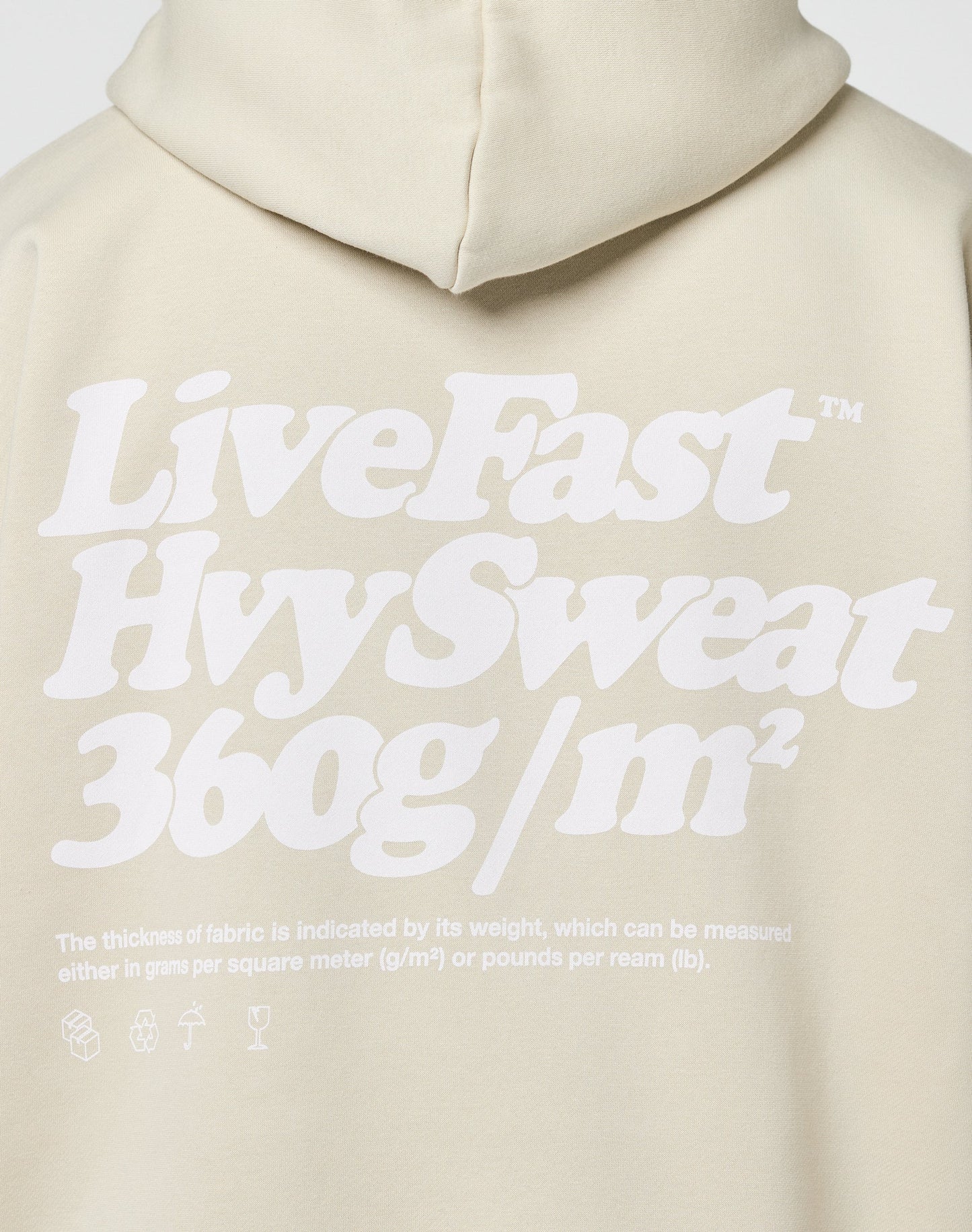 Back of a light beige Basic 360 Hooded by LIVE FAST DIE YOUNG, featuring bold white text: LiveFast Hvy Sweat 360g/m². Smaller text below lists a Baumwolle-Polyester fabric blend, with Oversize Fit icons shown at the bottom.