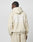 Wearing the Basic 360 Hooded by LIVE FAST DIE YOUNG, a person with braided hair, facing away from the camera against a light background, sports an oversize beige hoodie with Live Fast in white text on the back.