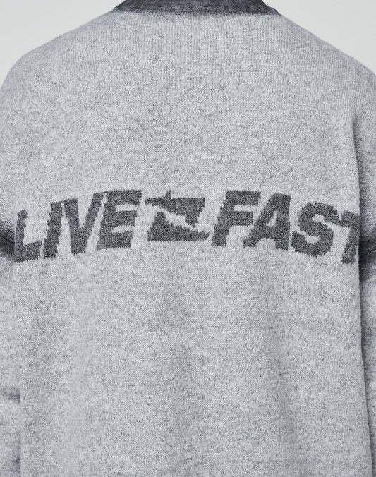 Back of a gray Live Fast Boucle Sweater by LIVE FAST DIE YOUNG, featuring "LIVE FAST" in bold print with the A as a running figure and a faded spray effect. Oversize fit adds comfort.