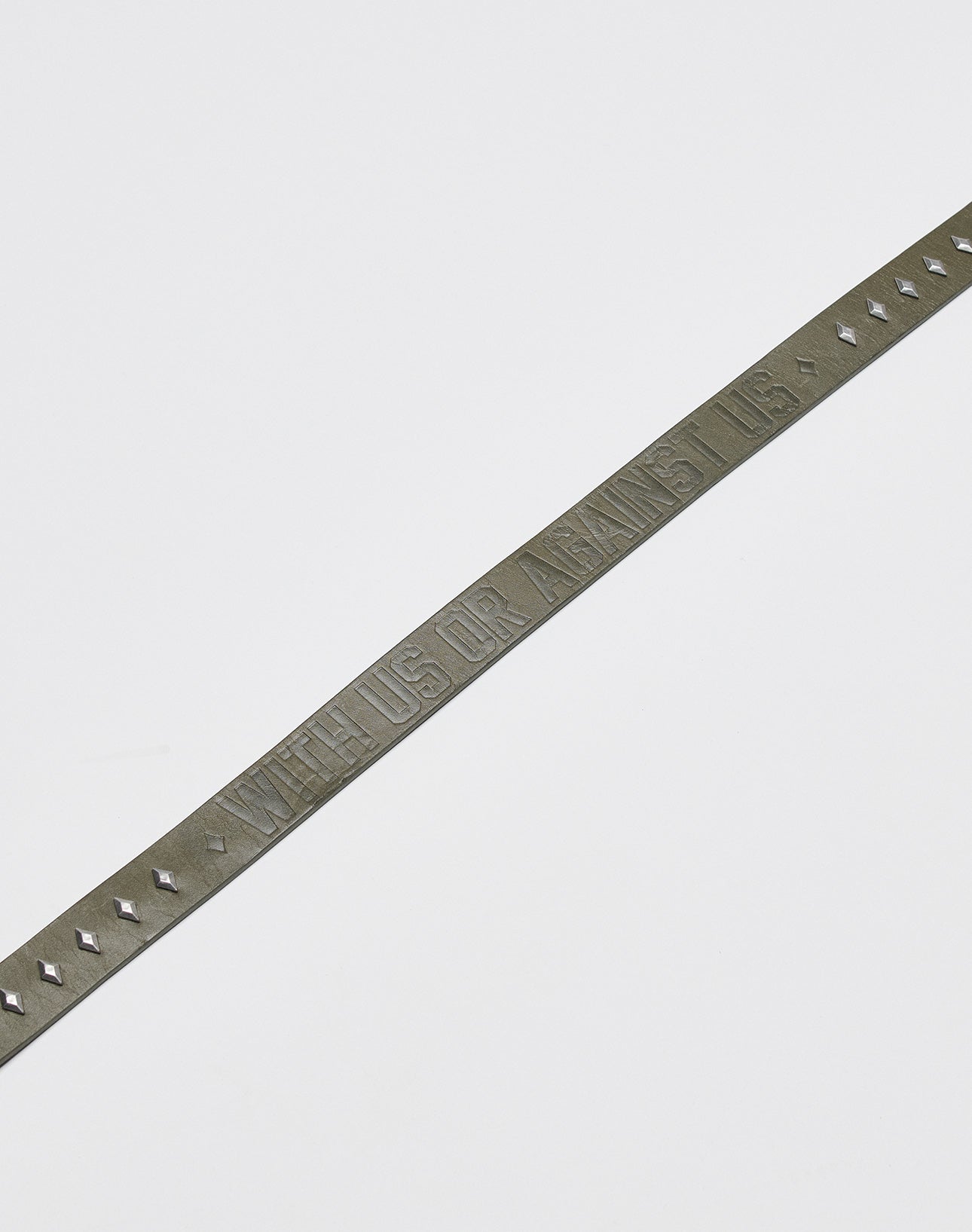 The LFDY Signature Belt by LIVE FAST DIE YOUNG is a slim, dark leather belt with small studs and a metal buckle, embossed with WITH US OR AGAINST US, shown on a plain white background.