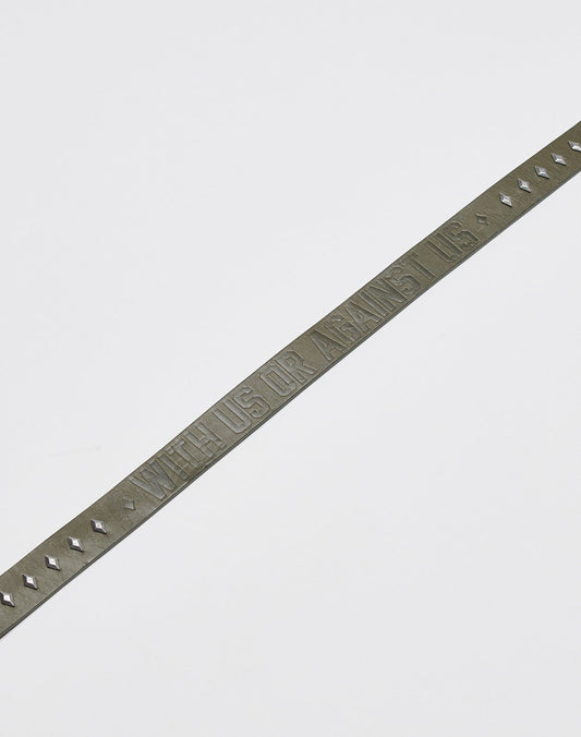 The LFDY Signature Belt by LIVE FAST DIE YOUNG is a slim, dark leather belt with small studs and a metal buckle, embossed with WITH US OR AGAINST US, shown on a plain white background.