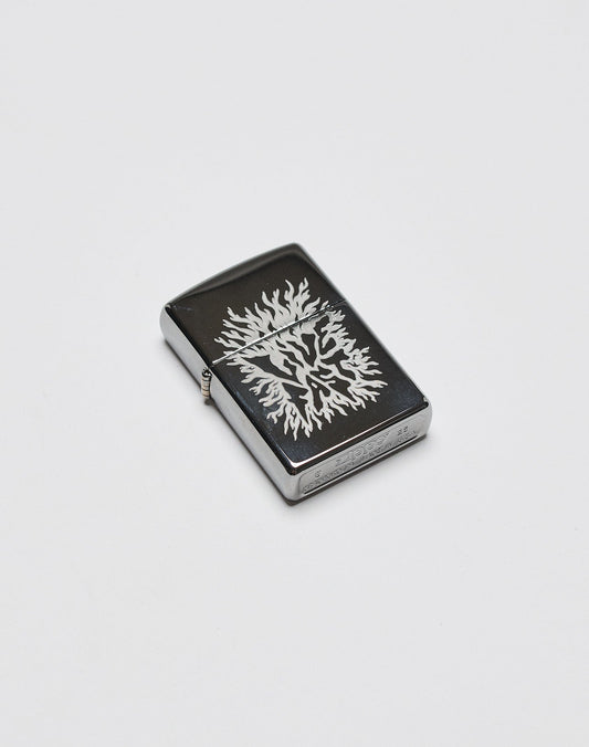 The LFDY x Zippo lighter by LIVE FAST DIE YOUNG features a black rectangular aluminum body with a silver tree design engraved on its surface, shown against a plain white background.