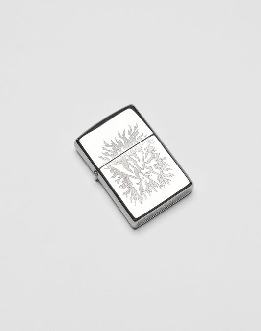 A silver rectangular LFDY x Zippo lighter by LIVE FAST DIE YOUNG features an engraved flame design on its aluminium case, displayed on a plain white background.| plain 