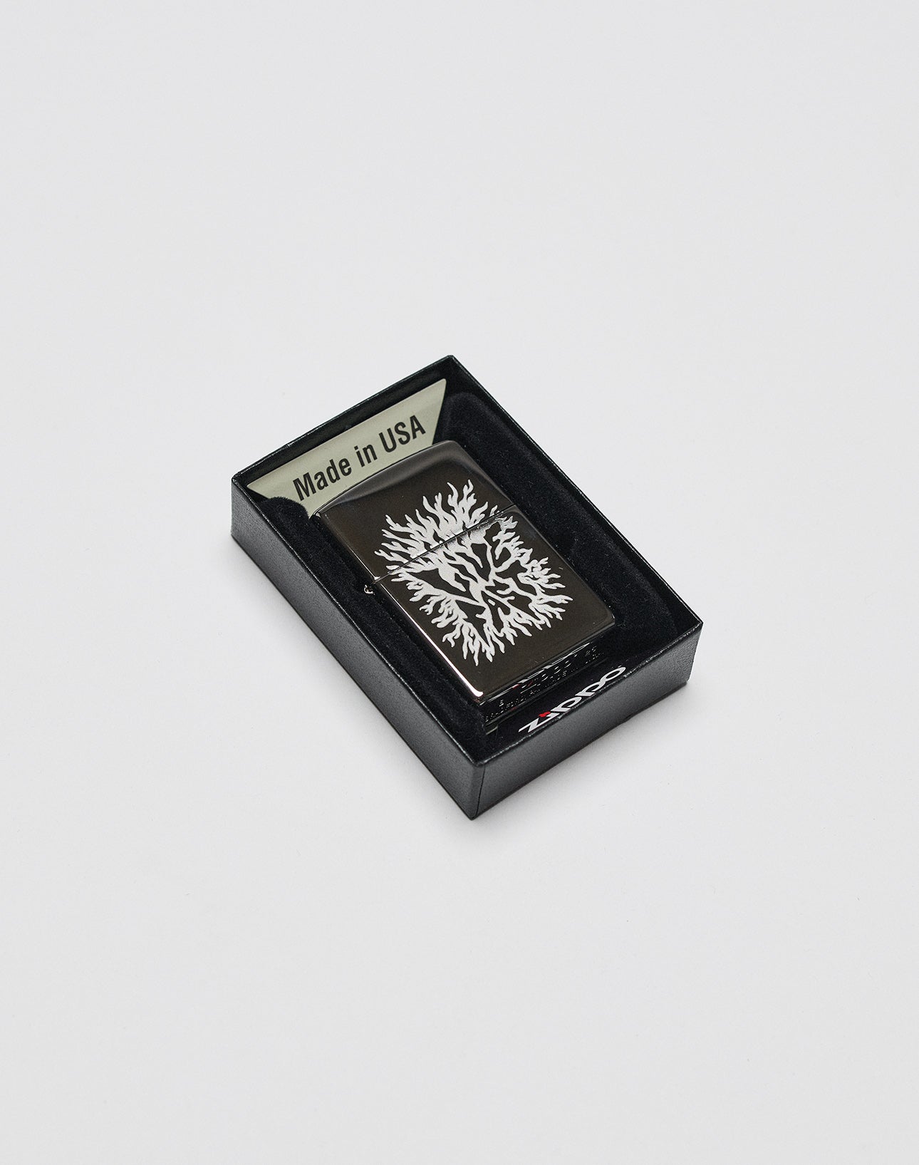 The LFDY x Zippo by LIVE FAST DIE YOUNG is a black limited edition lighter with a white flame design, shown in its open black box. The Aluminium-Gehäuse sits securely inside, featuring Made in USA on the inner lid.