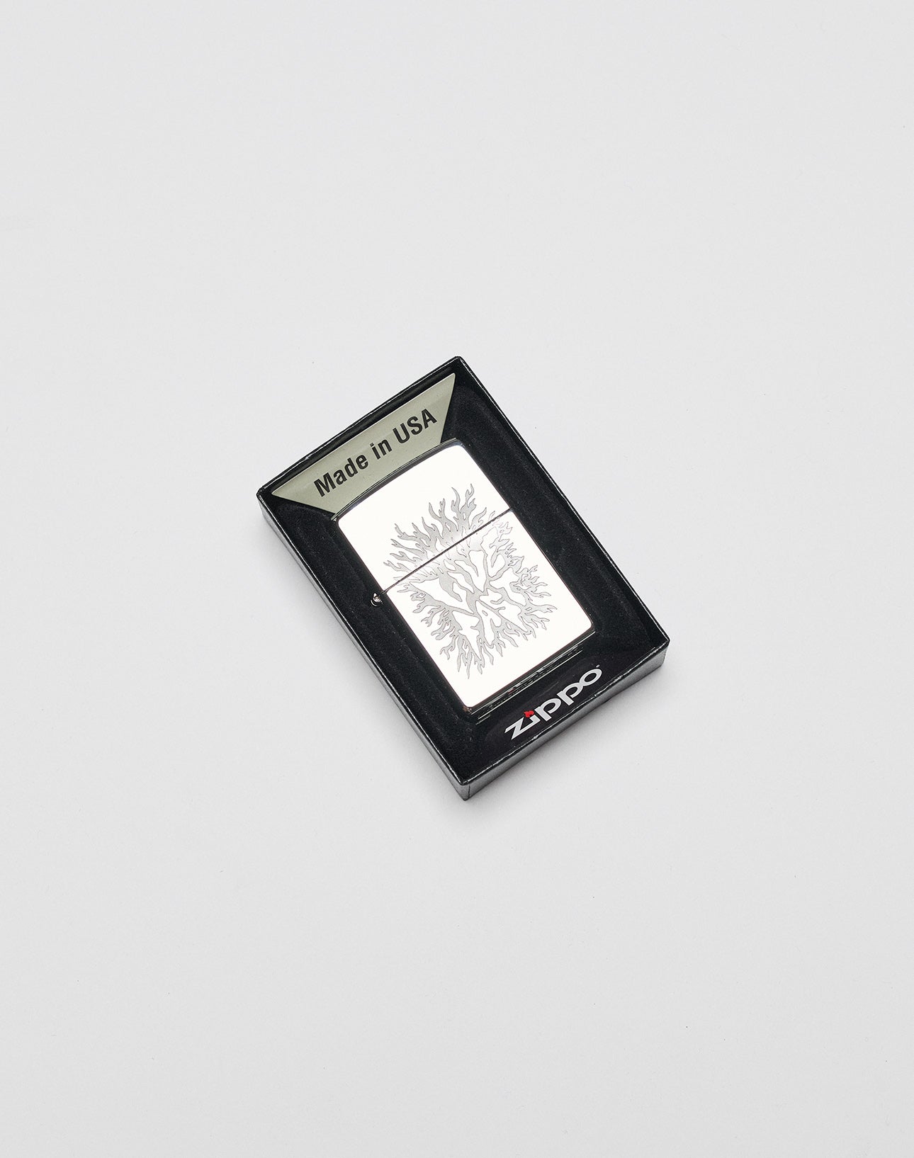 A silver LFDY x Zippo by LIVE FAST DIE YOUNG, featuring an engraved tree and aluminum case, is shown in a black box marked Made in USA against a white background.