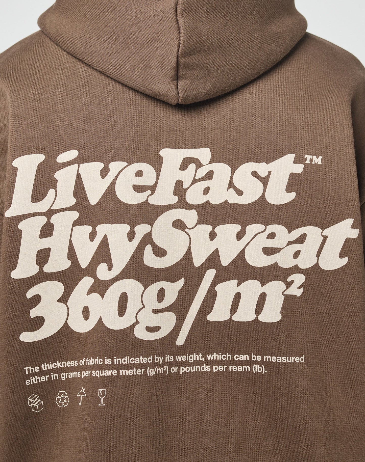 The LIVE FAST DIE YOUNG Basic 360 Hooded is a brown oversized hoodie with bold cream LiveFast HvySweat 360g/m² text, made from soft cotton and polyester. Small print notes fabric thickness is measured in grams per square meter.