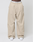 A person wears LIVE FAST DIE YOUNG Baggy Nylon Pants with aufgesetzte Taschen, white sneakers, and a white elastic waistband that reads LIVE FAST against a plain light background.