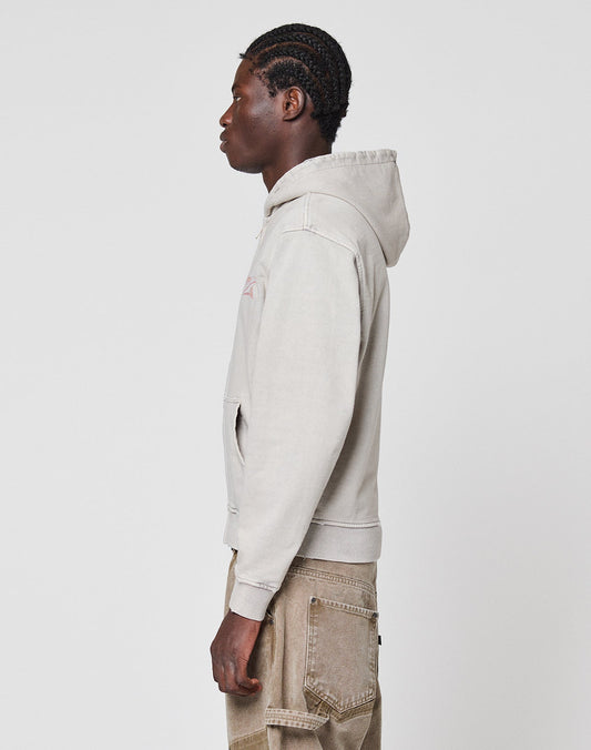 A person with braided hair, dressed in a light gray LFDY Corp. Hooded Zip by LIVE FAST DIE YOUNG and brown cargo pants, stands in profile against a plain white background.