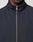 A close-up shows a person wearing the LFDY Striped Track Jacket by LIVE FAST DIE YOUNG, featuring a dark navy color, high collar, raglan sleeves, and a centered silver zipper. Only the lower half of the face and upper chest are visible.