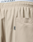 Close-up of Baggy Nylon Pants by LIVE FAST DIE YOUNG featuring an elastic waistband, patch pockets, a visible side pocket, and a small fabric tag labeled TIBY. The LIVIFAST text is partially visible on the waistband.
