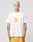 A person with short, bleached blonde hair wears a loose white LFDY Fries Tee by LIVE FAST DIE YOUNG, featuring a graphic of fries in a red carton labeled “Everybody Fries,” and yellow shorts, against a plain light gray background. LF2406-15695.