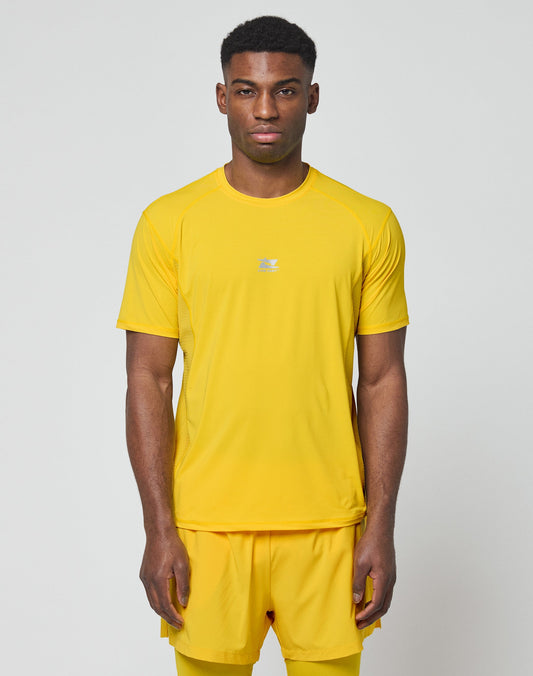 A man faces forward in the LIVE FAST DIE YOUNG Live Fast Performance Tee and matching shorts, slim fit, bright yellow with reflective print, set against a plain light gray background.| model