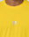 Close-up of a person in the LIVE FAST DIE YOUNG Live Fast Performance Tee, a bright yellow slim fit athletic shirt with a white LIVE FAST logo and reflective chest print. Only the lower face and upper chest are visible.