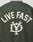 The Live Fast College Jacket by LIVE FAST DIE YOUNG has bold beige LIVE FAST lettering and a stylized emblem on the back, with striking contrast-color details for a standout dark green look.