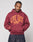 Someone wearing the Live Fast Stallion Hooded by LIVE FAST DIE YOUNG, a maroon oversized hoodie featuring yellow LIVE FAST text and two tigers graphic, made from a soft cotton-polyester blend, stands with hands in the pocket and looks down.