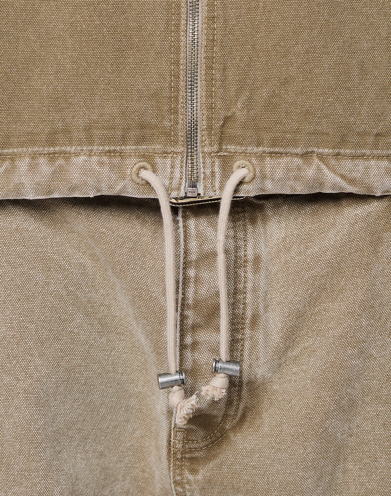 Close-up of the Faded Workwear Jacket by LIVE FAST DIE YOUNG—tan, oversize fit with a metal zipper, kangaroo pocket, metal-tip drawstring, and textured fabric.