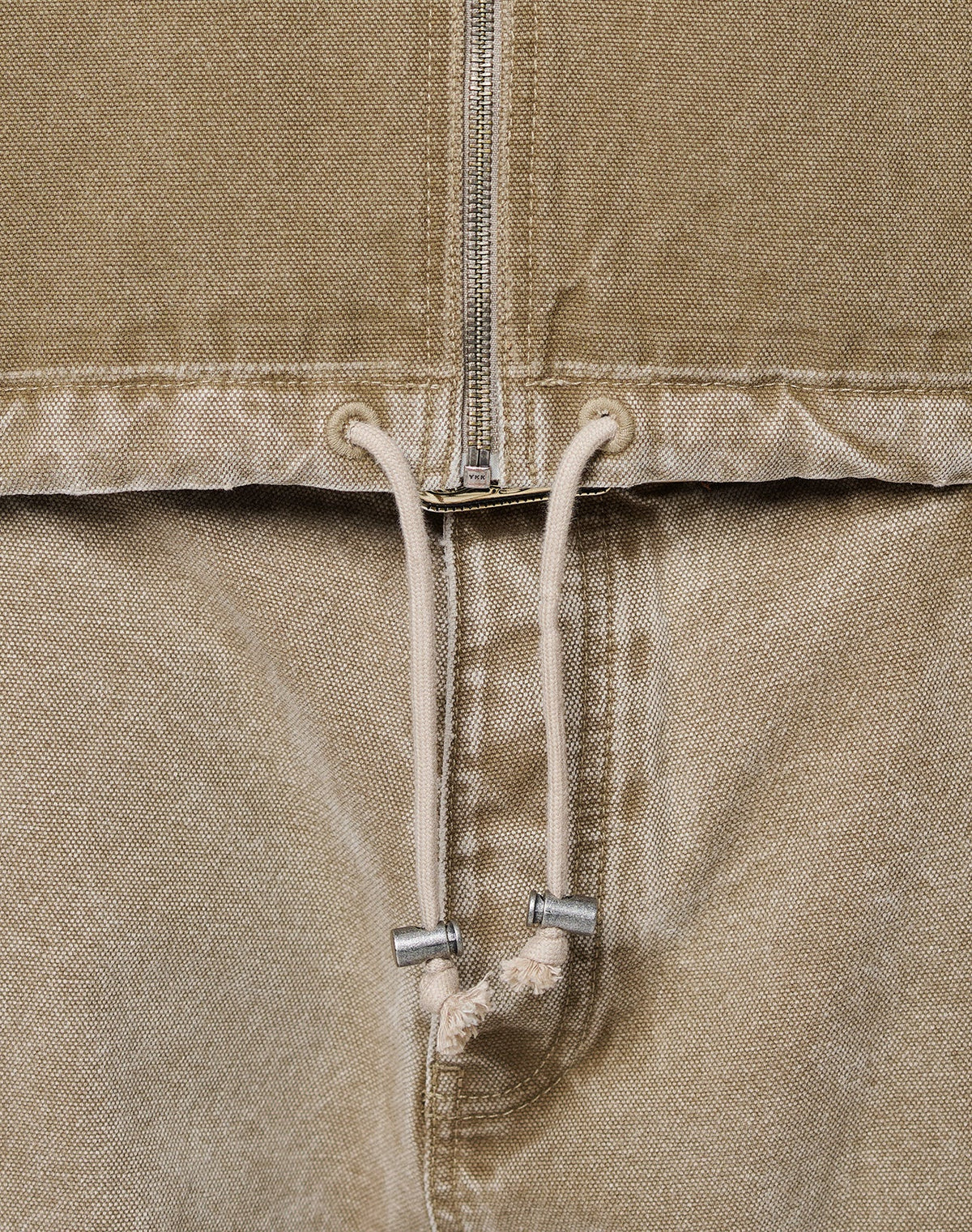 Close-up of the Faded Workwear Jacket by LIVE FAST DIE YOUNG—tan, oversize fit with a metal zipper, kangaroo pocket, metal-tip drawstring, and textured fabric.