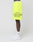 A person stands sideways wearing neon yellow LFDY Guaranteed Mesh Shorts by LIVE FAST DIE YOUNG with black Approval GUARANTEED +49LiveFast text, white LEDX socks, and white Nike sneakers against a plain white background.