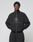 A person wearing the black LFDY Dealership Trackjacket by LIVE FAST DIE YOUNG, featuring a Stehkragen, "LIVE FAST," and a stylized logo on the front, stands against a light gray background with hands in pockets.