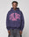 A person wearing the LIVE FAST DIE YOUNG Live Fast Stallion Hooded, an oversize navy cotton hoodie with a pink LIVE FAST horse graphic, stands against a plain light grey background.