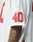 A close-up shows a person wearing the LFDY Mesh Jersey by LIVE FAST DIE YOUNG, an oversize white sports jersey with red 40 on the sleeve, mesh polyester fabric, and V-neck. Tattoos are visible on their arm.
