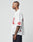 A man with neck and hand tattoos wears the LIVE FAST DIE YOUNG LFDY Mesh Jersey in white with red 40 on the sleeve, 00 on the front, oversize fit, V-neck, and pairs it with dark pants.