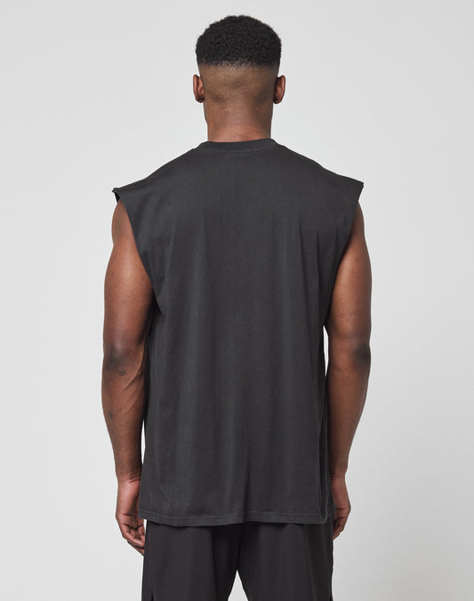 A man stands with his back to the camera wearing the LFDY Canine Muscle Shirt by LIVE FAST DIE YOUNG and black shorts, set against a plain light gray background.