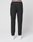 Someone stands facing away, wearing LFDY Performance Pants by LIVE FAST DIE YOUNG with an elastic waistband, branded details, and a reflective logo print, paired with white sneakers, against a plain light background.