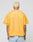 A person with short, bleached blonde hair is seen from behind wearing the LIVE FAST DIE YOUNG LFDY Boxy Jersey in yellow mesh and light blue jeans, set against a plain gray background.