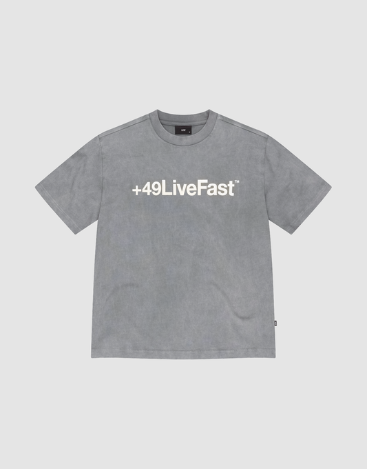 The Basic +49 Tee by LIVE FAST DIE YOUNG is a grey oversized short-sleeve t-shirt featuring a bold white +49LiveFast™ front print, made from 100% cotton and shown on a plain light background. | plain