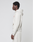 A person in profile wears the LIVE FAST DIE YOUNG LFDY Heavyweight Lounge Zip Hooded in light beige with matching sweatpants, standing against a plain light background.