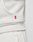 Close-up of a person in the LFDY Heavyweight Lounge Zip Hooded by LIVE FAST DIE YOUNG and matching sweatpants, featuring a small red tag with white text on the side seam near the waist.