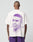 A person stands with their back to the camera wearing the LFDY Originals Tee by LIVE FAST DIE YOUNG—an oversized white cotton T-shirt featuring a large purple portrait backprint and Live Fast Originals text beside the image.