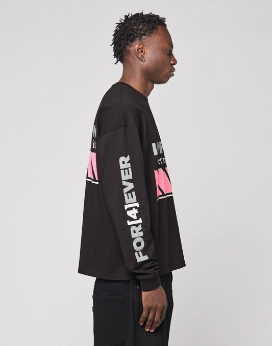 A person in profile wears the LFDY Racing Longsleeve by LIVE FAST DIE YOUNG, a black 100% Baumwolle top with bold white and pink graphic text and reflektierender Print on the back, front, and sleeves.