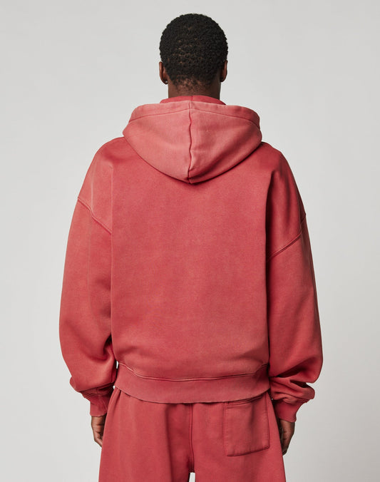 A person is seen from the back in a loose-fitting, vintage wash red Live Fast Sweatsuit Jacket by LIVE FAST DIE YOUNG with matching sweatpants, standing against a plain light gray background.