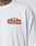 A person in the Live Fast 2013 Tee by LIVE FAST DIE YOUNG—a regular fit white shirt with LIVE FAST DIE YOUNG in bold orange, 2013 LFDY 2013, and Textilvertretieb GmbH on a chest patch. Part of a tattooed neck is visible.