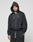 A person in a black LIVE FAST DIE YOUNG LFDY Lightweight Hooded Zip with the hood up and matching black sweatpants stands against a light gray background, looking directly at the camera with a neutral expression.