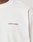 A close-up of the LFDY Grand Theft Tee by LIVE FAST DIE YOUNG, a white 100% Baumwolle crewneck with "LIVE FAST™" in small bold purple letters on the left chest.