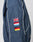 The LFDY Canvas Jacket by LIVE FAST DIE YOUNG is a navy blue racer with white piping, featuring four multicolored flag patches—UK, Estonia, Germany, Belgium—stacked on the sleeve and finished with elastic cuffs.